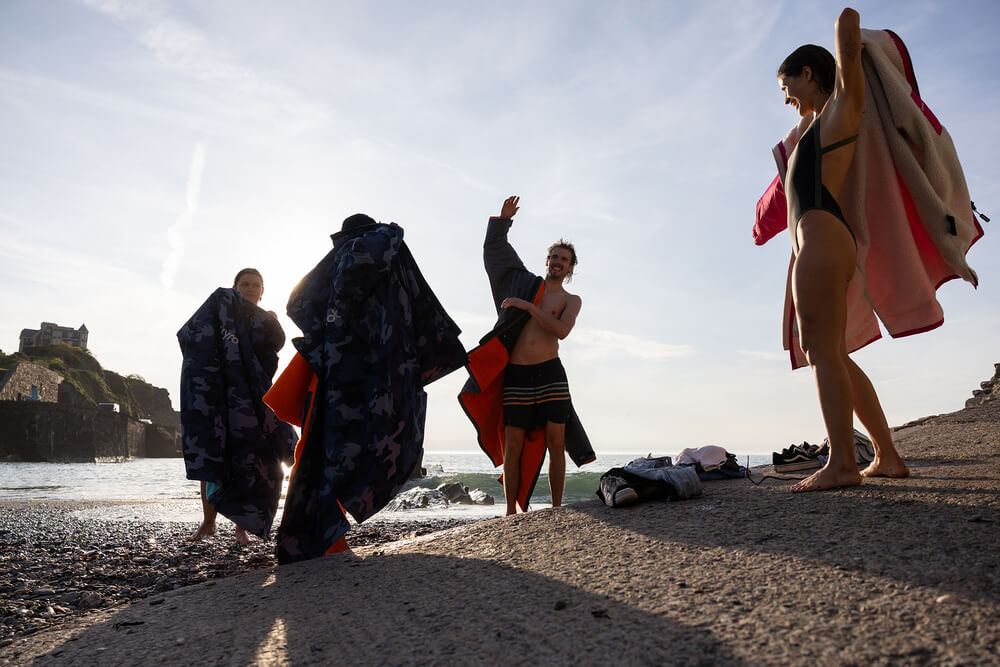 Why are Dryrobes so popular? A group of friends getting dry and changed in their Dryrobes after a wild swim.